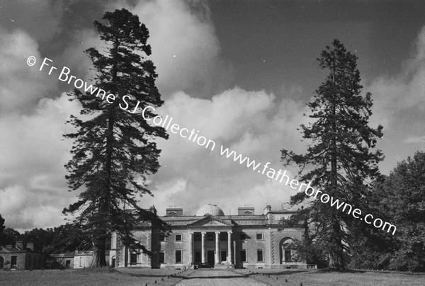 FRONTAL VIEW OF HOUSE WITH CLOUDS FROM AVENUE